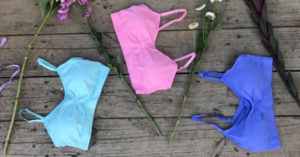 three bras with flowers by them