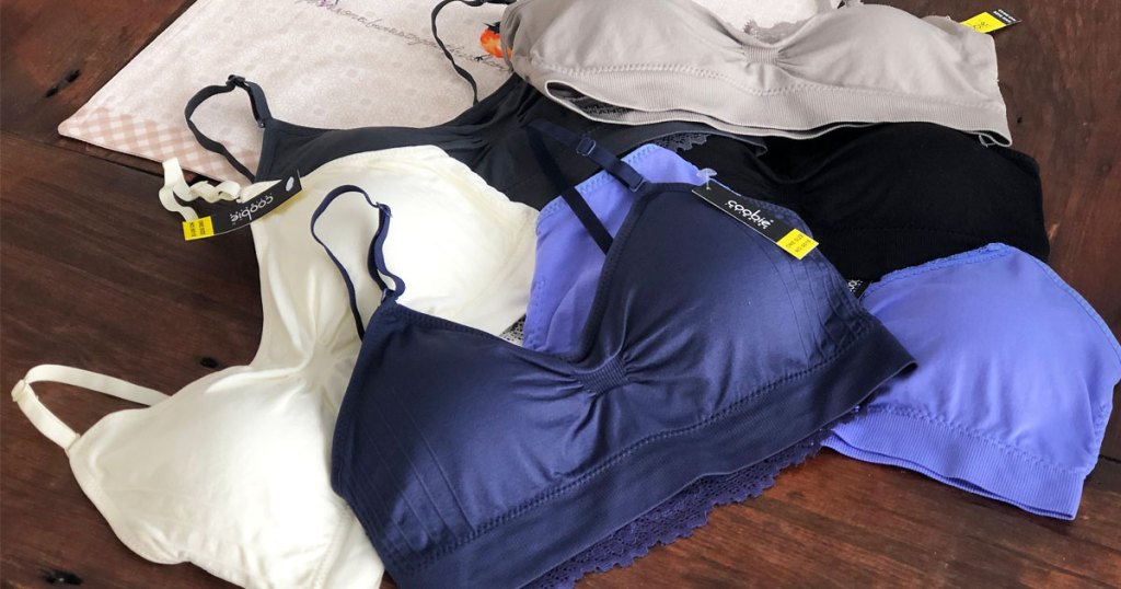 pile of women's bras on a wood table