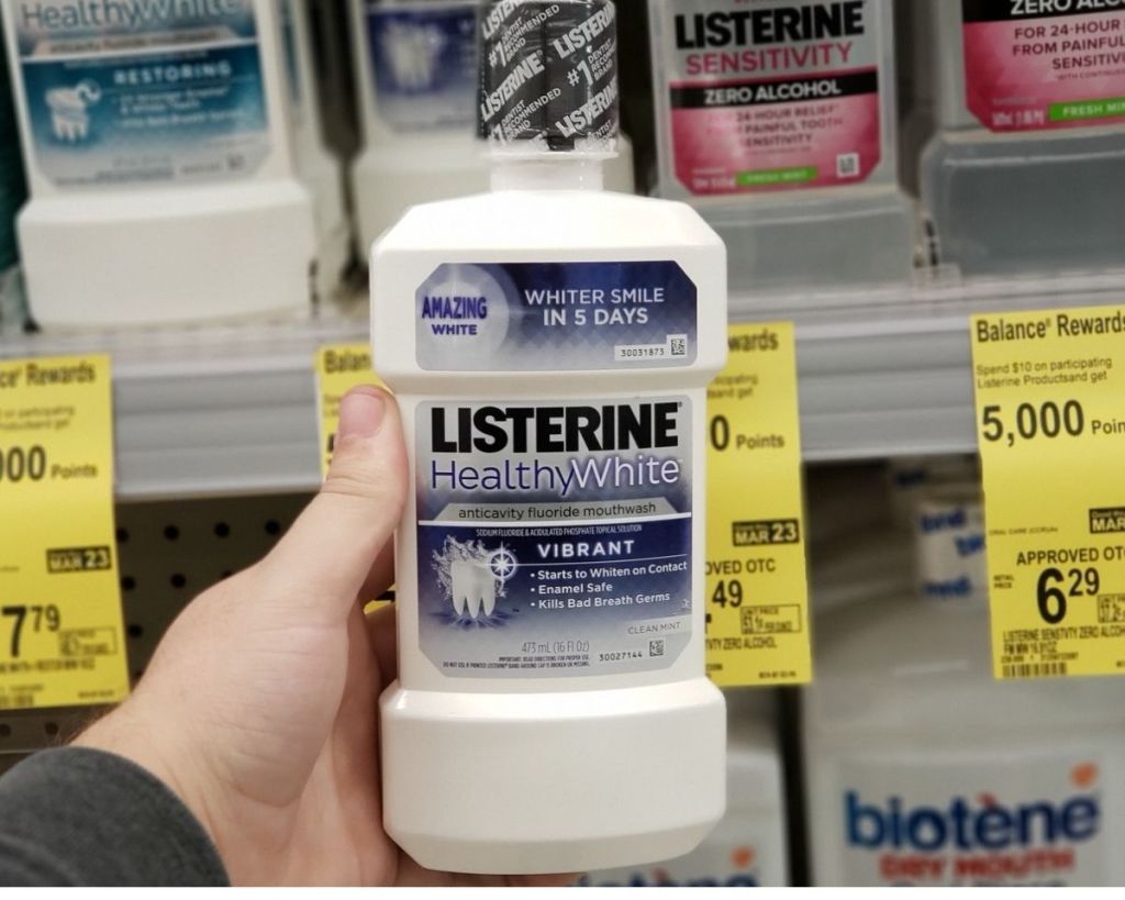 hand holding Listerine HEalthy White Vibrant