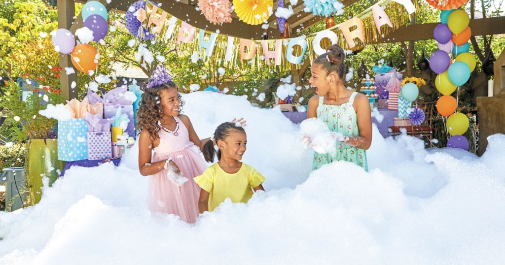 girls playing in large pile of foam bubbles