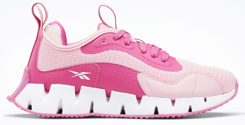 pink reebok shoe with zigzag shaped sole