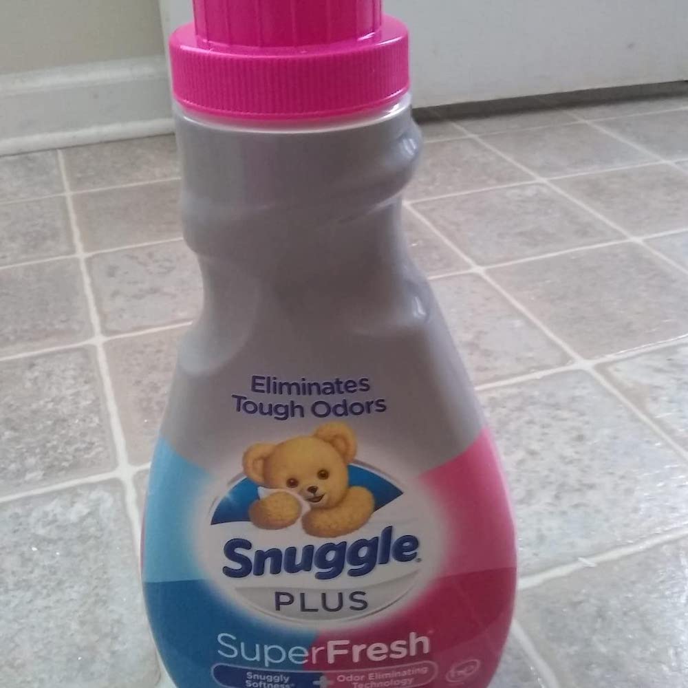 Snuggle Fabric Softener bottle sitting on tile floor