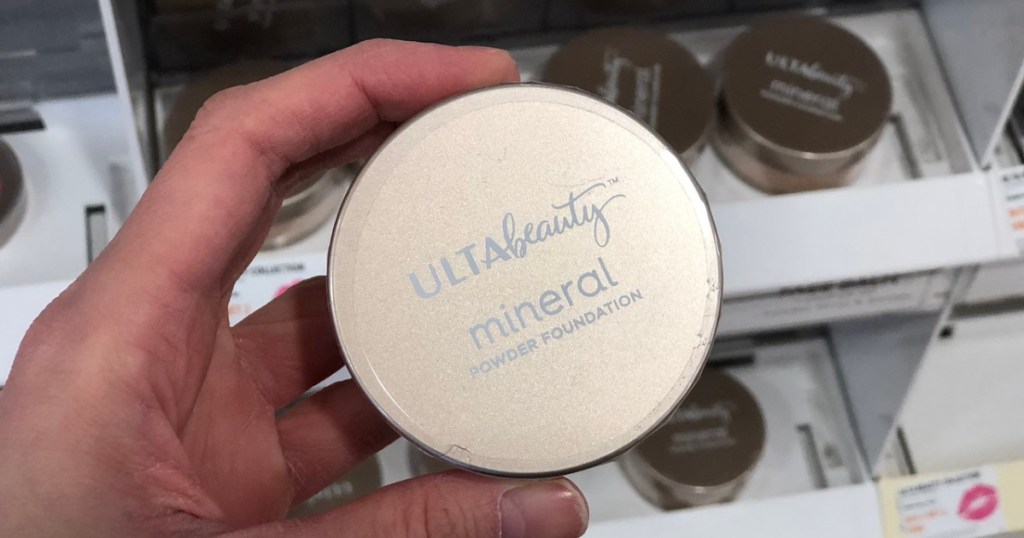 hand holding mineral powder foundation in store