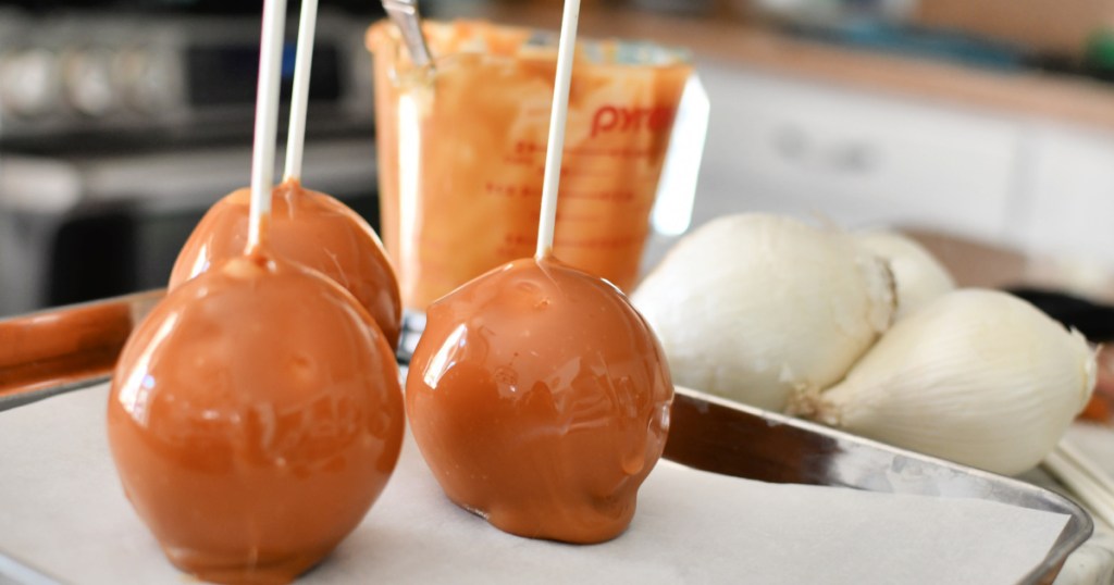 caramel dipped apples on a sheet pan