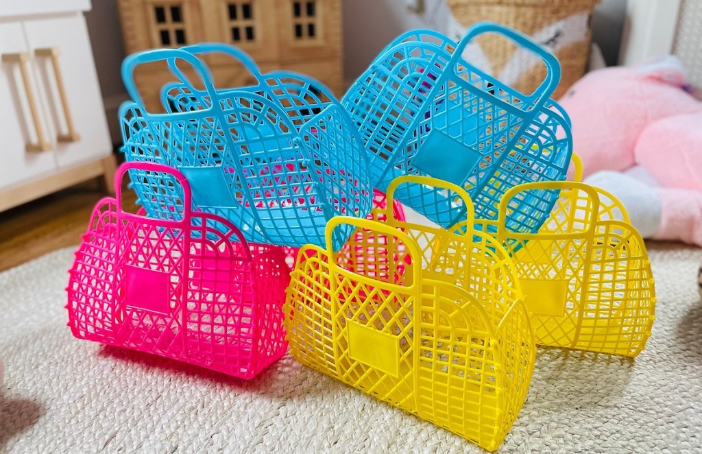 pile of colorful pink blue and yellow plastic purses on floor