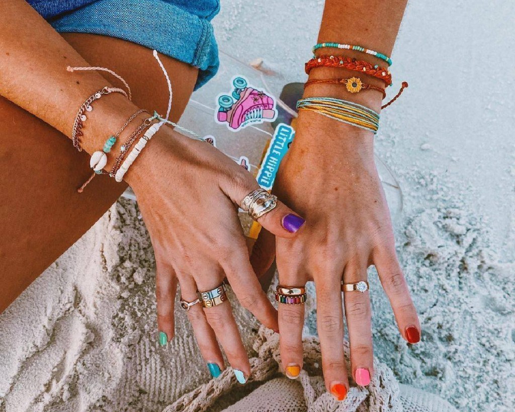 pura vida rings and bracelets on hands