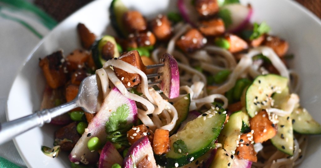 fork lifiting noodles and vegetables