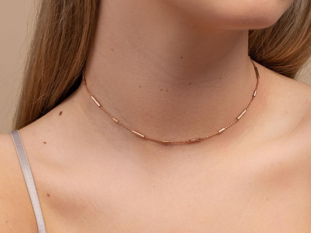 woman wearing rose gold necklace