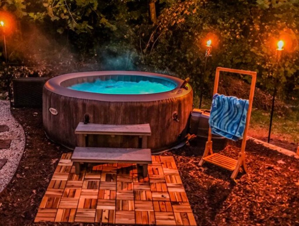 inflatable hot tub outside with string lights