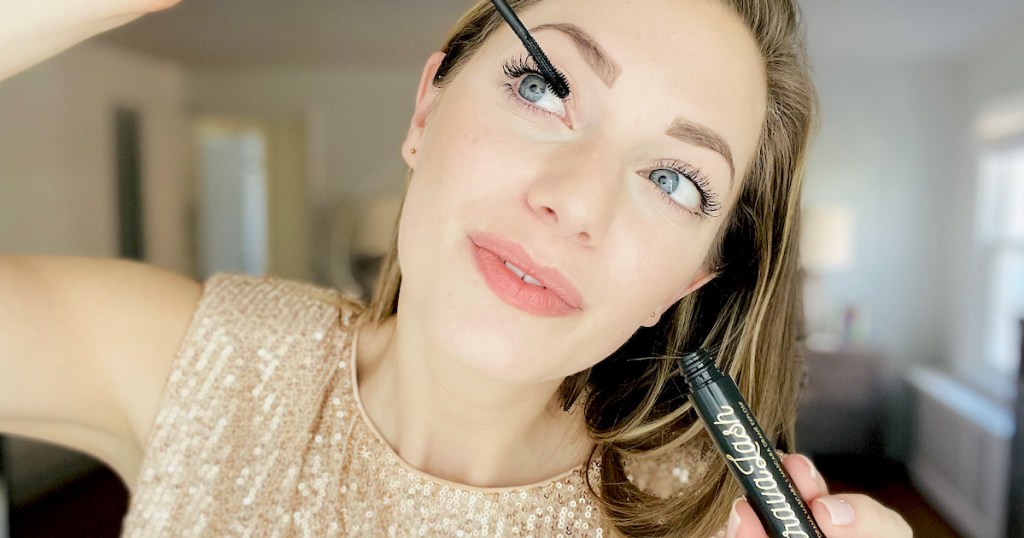 woman putting on winky lux mascara