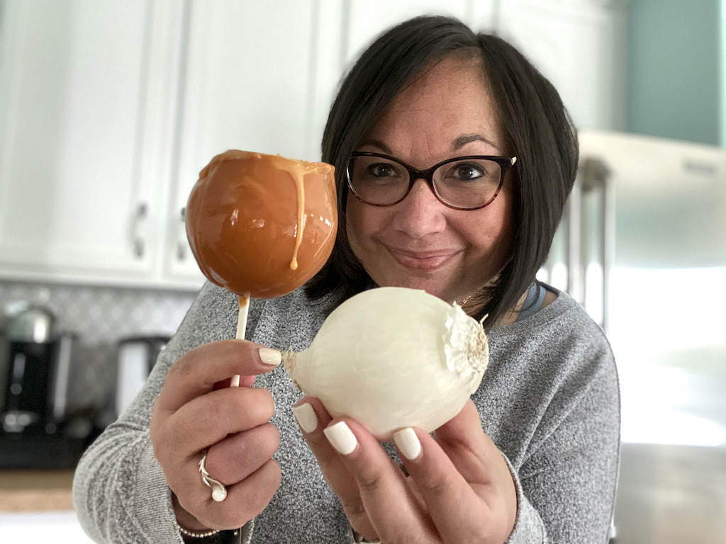 woman holding raw onion and caramel onion 