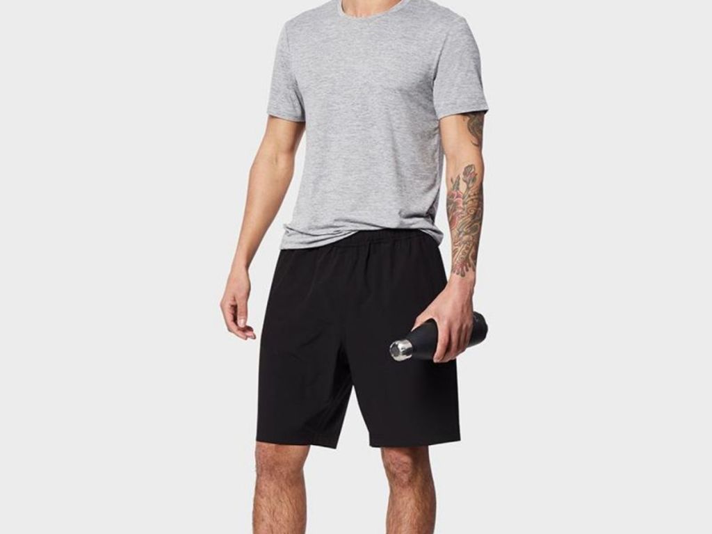 man wearing gray tee and black shorts