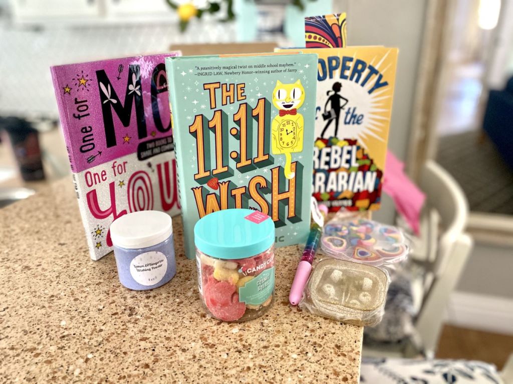 books, candy and writing supplies on a table