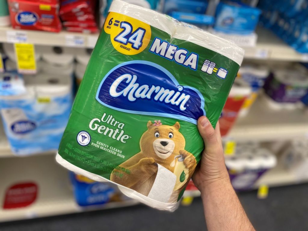 hand holding a package of Charmin Ultra Toilet Paper