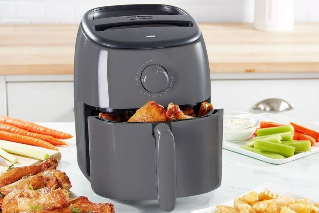 Dash 2.6 qt Air Fryer on counter with food in gray