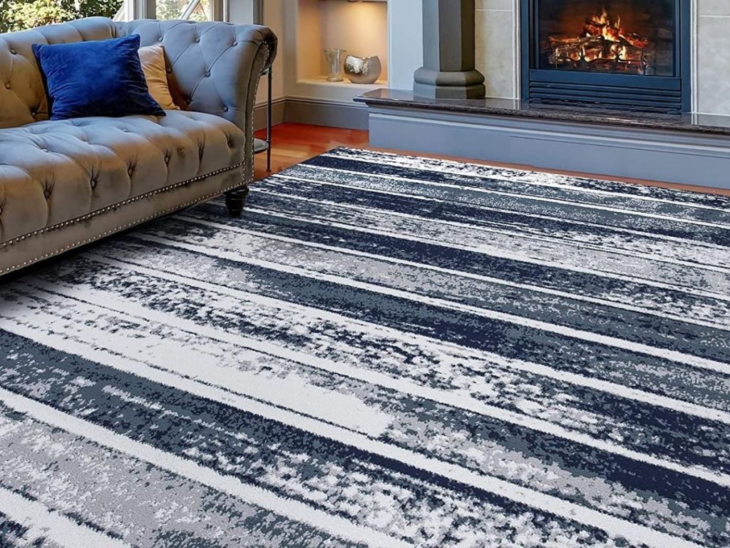 area rug in room with fireplace and couch