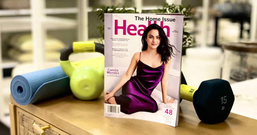 issue of health magazine next to yoga mat and hand weights