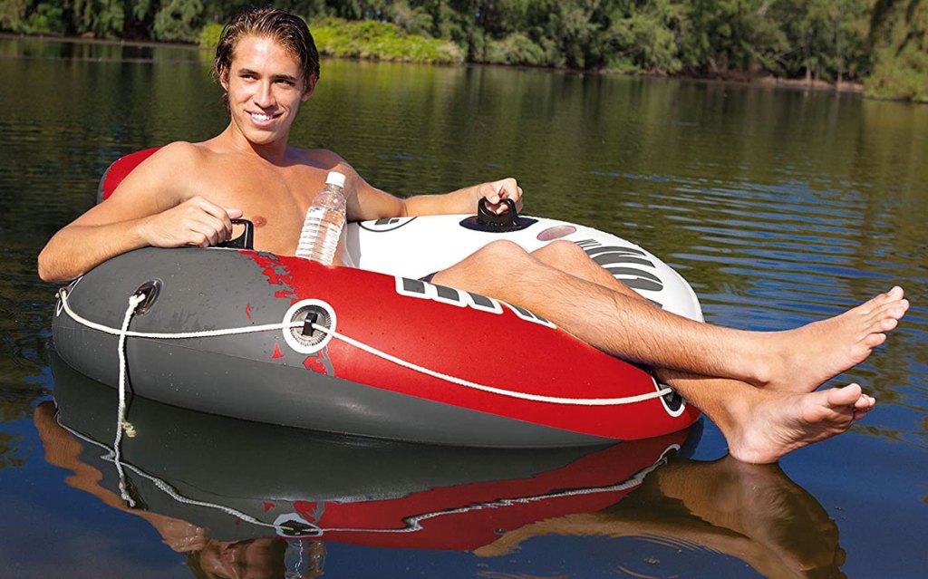 man in pool tube in a river