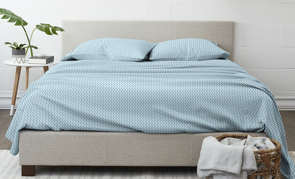 bed with sheets and pillows on it