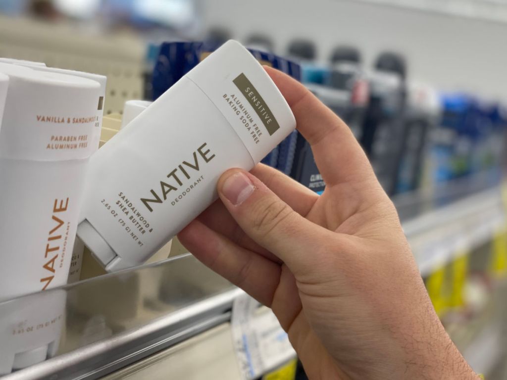 Man pulling Native Deodorant off a store shelf