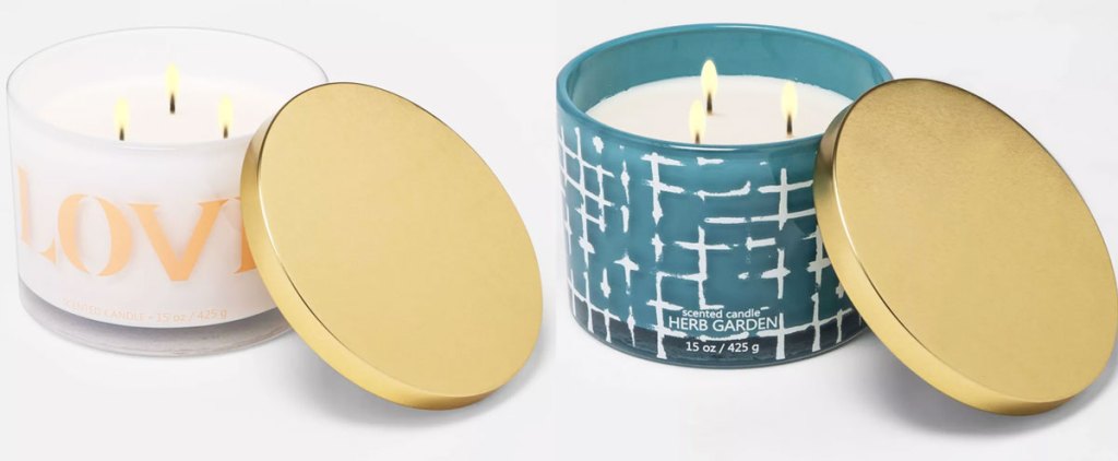 two lit 3 wick candles with gold lids