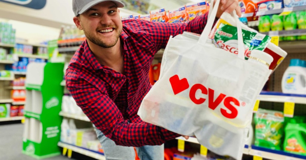 man holding CVS bag full of products