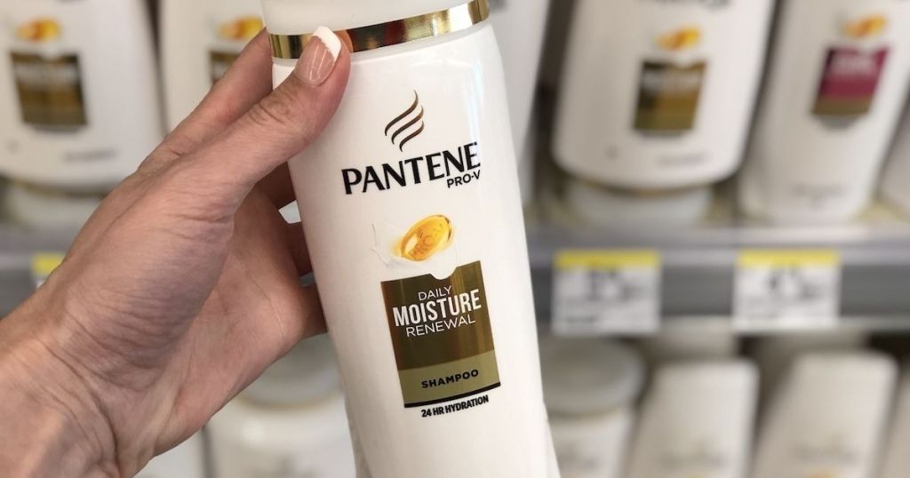 hand holding Pantene Shampoo in store