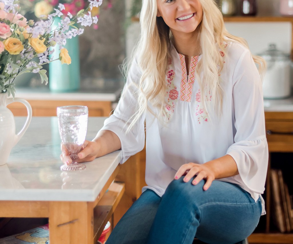 Woman wearing white embroidered top