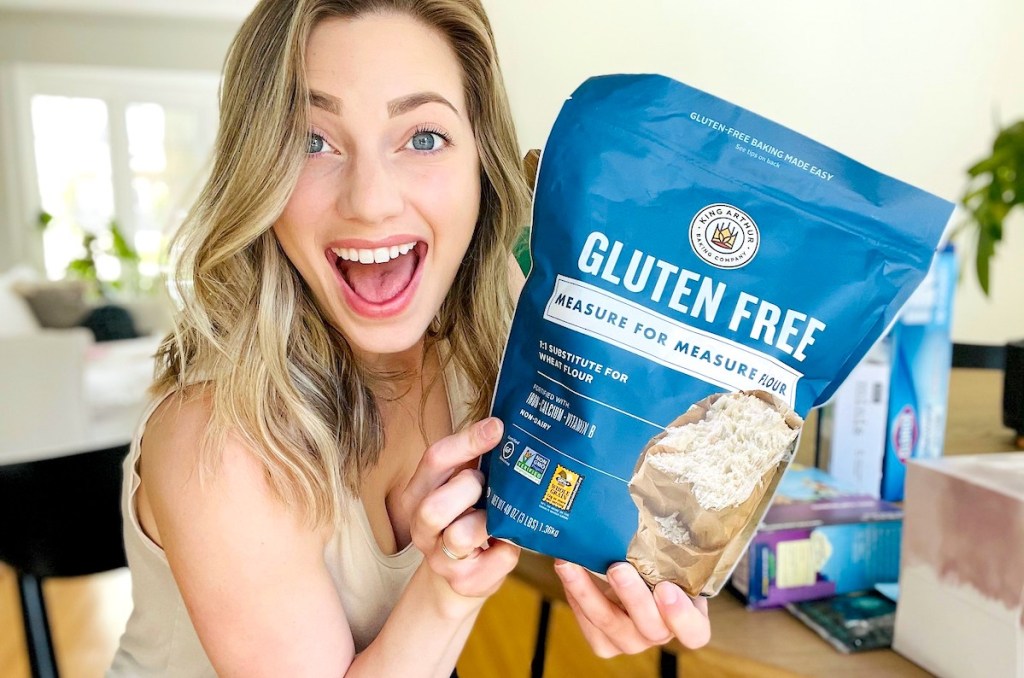 woman holding a bag of king arthur gluten free flour