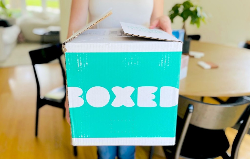 close up of woman holding boxed box in hands