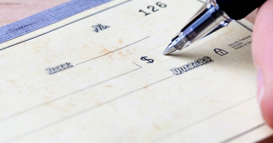 close up of pen on blank checkbook