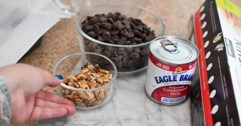 bowl of chocolate chips, walnuts, and sweetened condensed milk