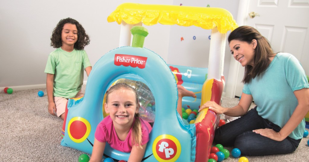kids in fisher price train ball pit