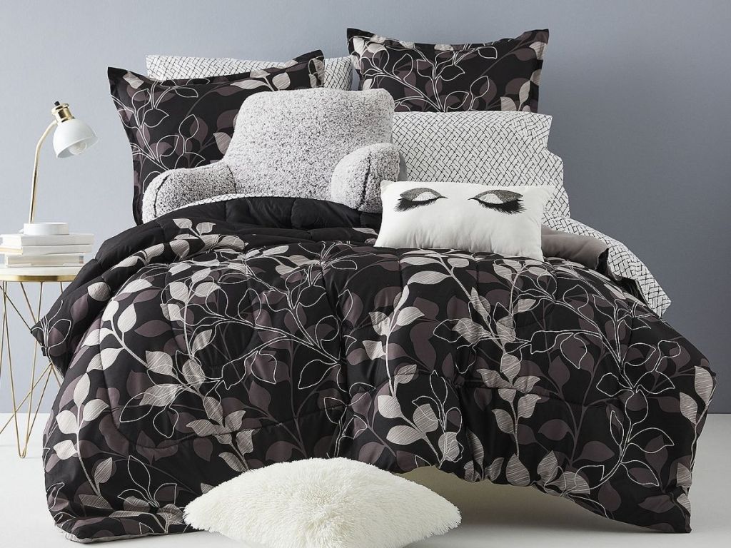 silver and black leaf reversible comforter set on bed