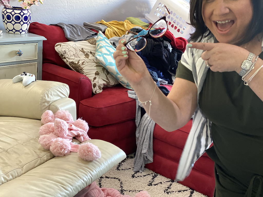 woman holding magical house cleaning glasses