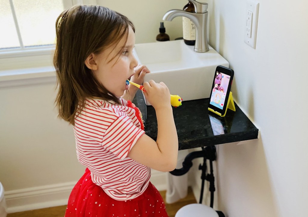 child brushing teeth in bathroom