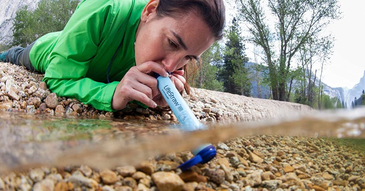 woman usiong lifestraw in water