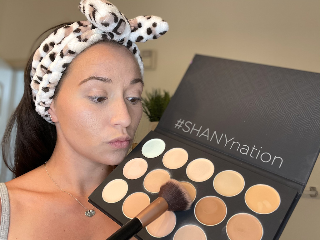 woman holding large cosmetics palette 