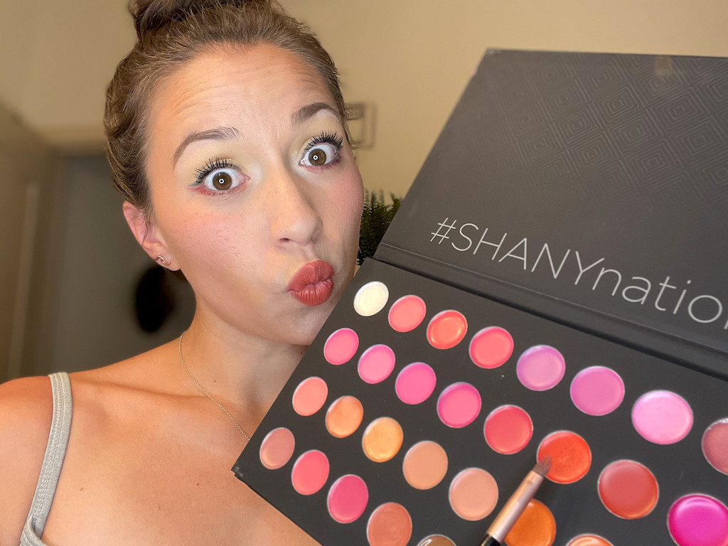 woman making kiss face holding Shany cosmetics 