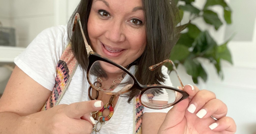 woman pointing to eyeglasses