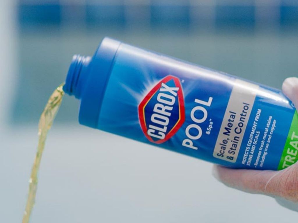 hand pouring Clorox liquid from bottle