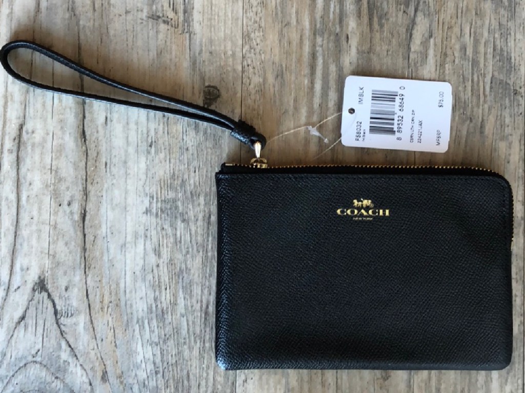 black leather wristlet on wood surface