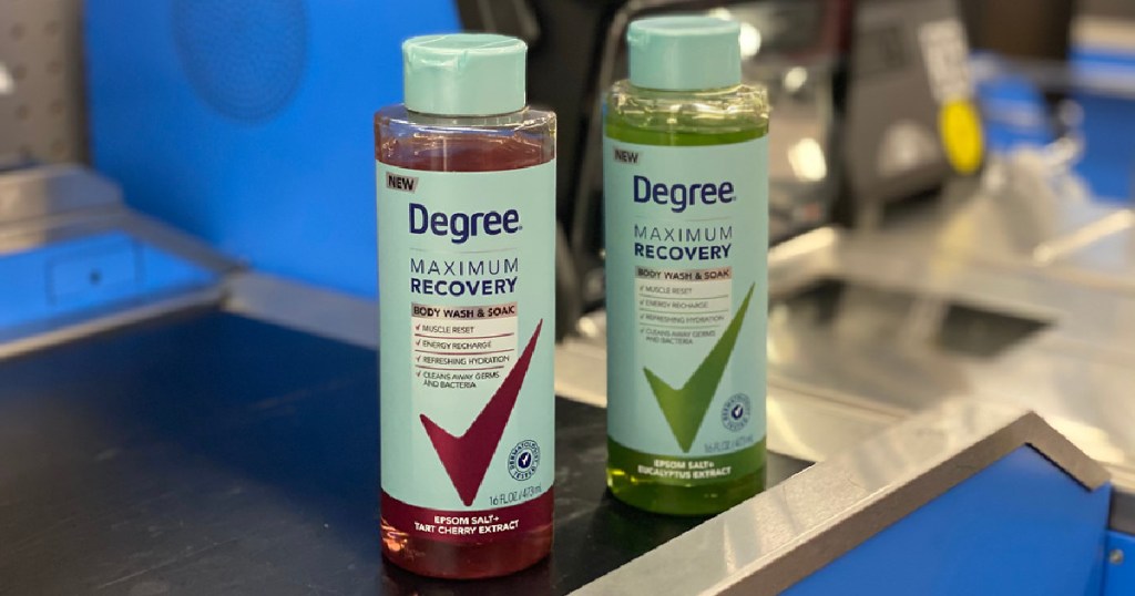 two bottles of body wash and soak on store checkout conveyor belt