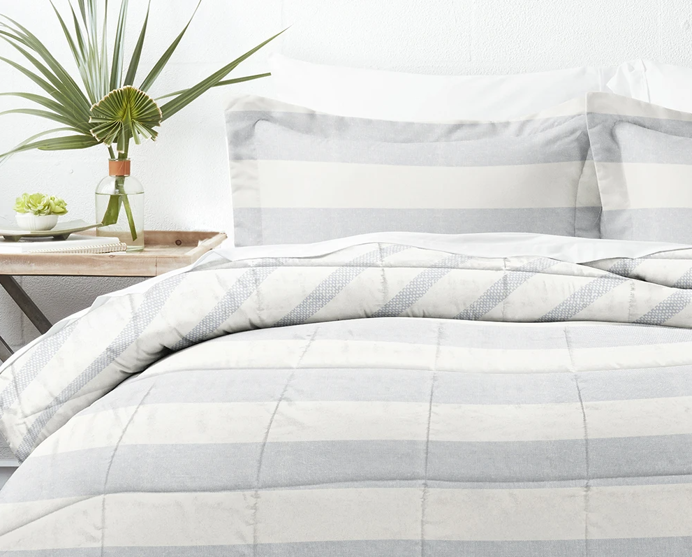 striped comforter on a bed