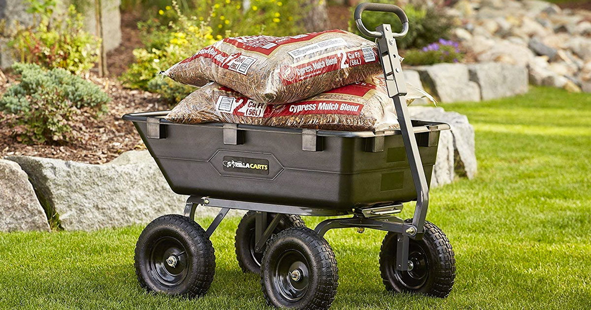 black yard cart filled with bags of mulch