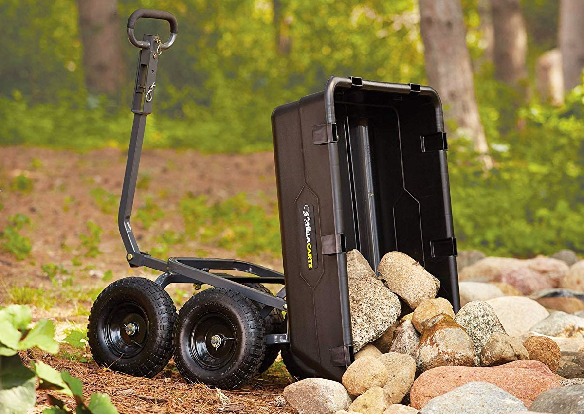 black yard cart dumping load of rocks