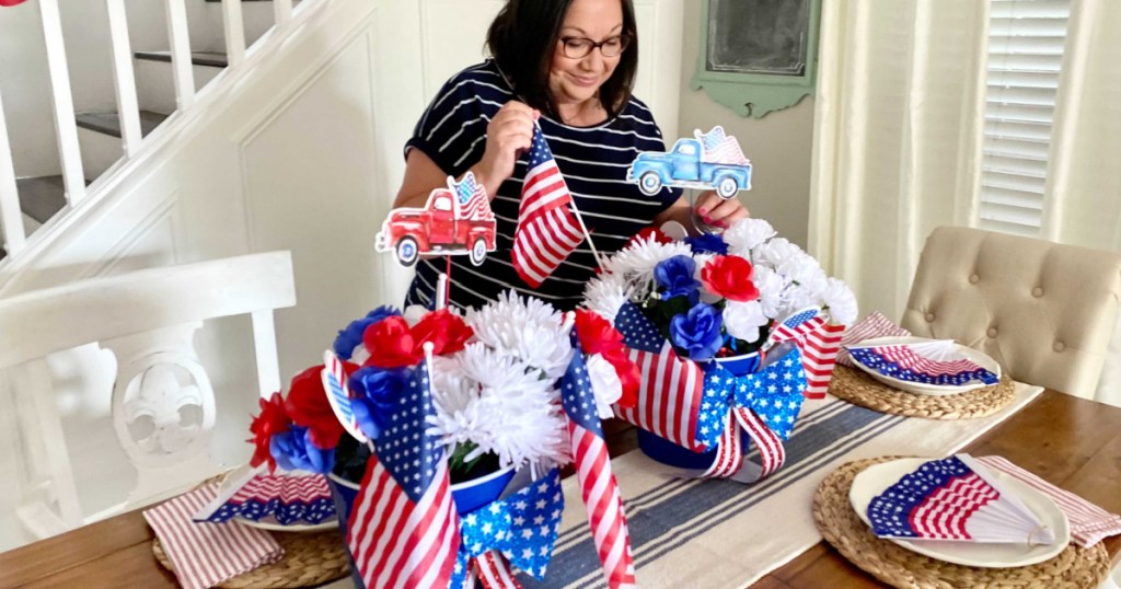 woman decorating with dollar tree party supplies and patriotic decor 