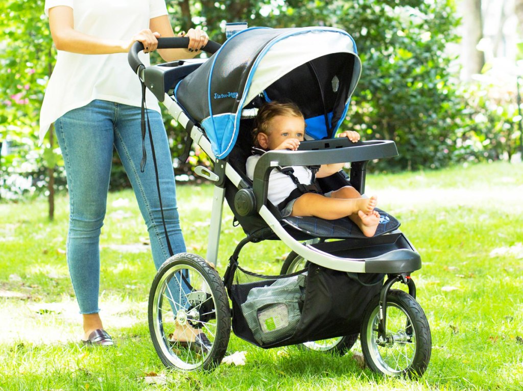 woman pushing child in jogger stroller