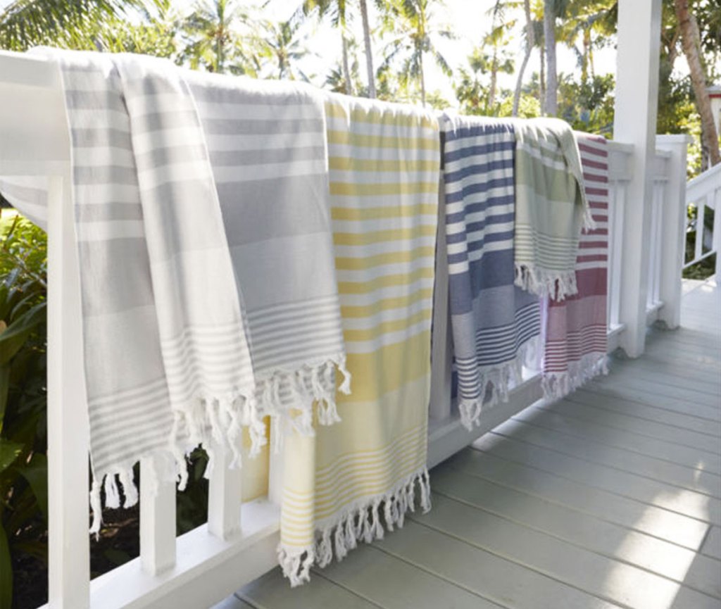 striped beach towels hanging over rail