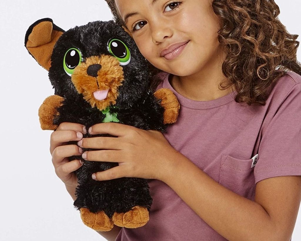 child holding Little Tikes Yorkie Cuddle Pup